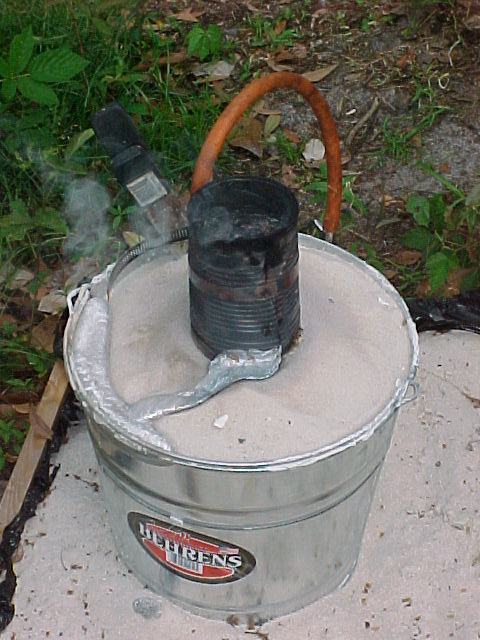 bucket with foam pattern in it after pouring aluminum.jpg
